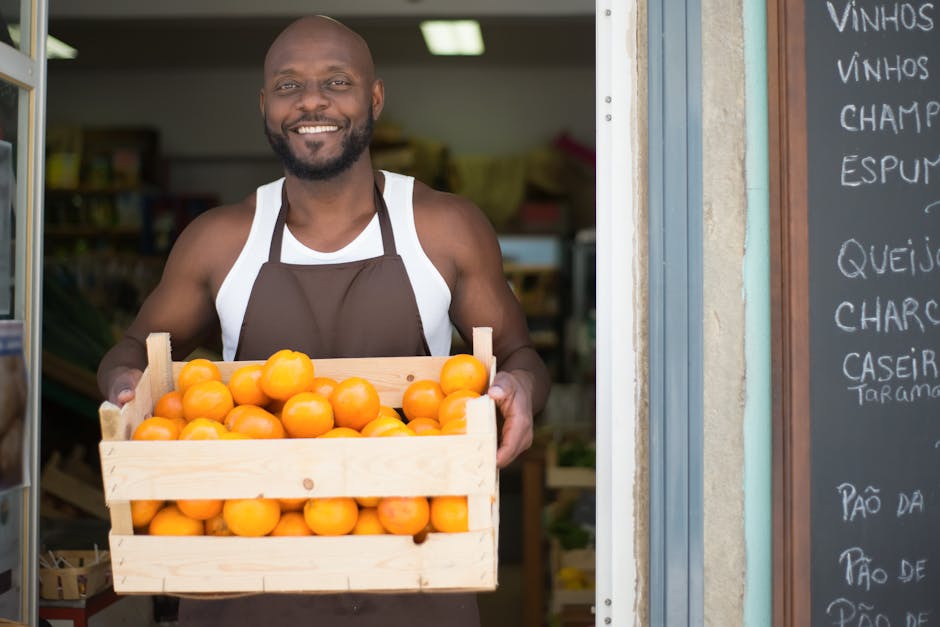 Happy vendor holding a crate of oranges at a local store in Portugal.