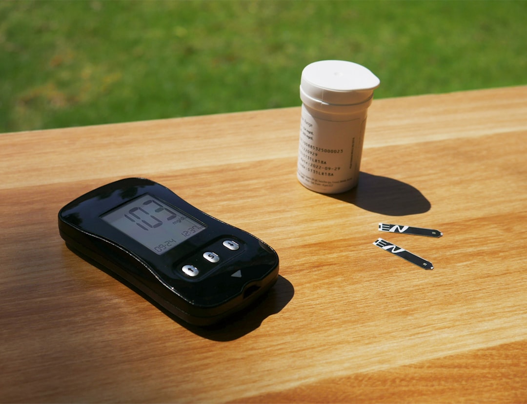 a cell phone sitting on top of a wooden table