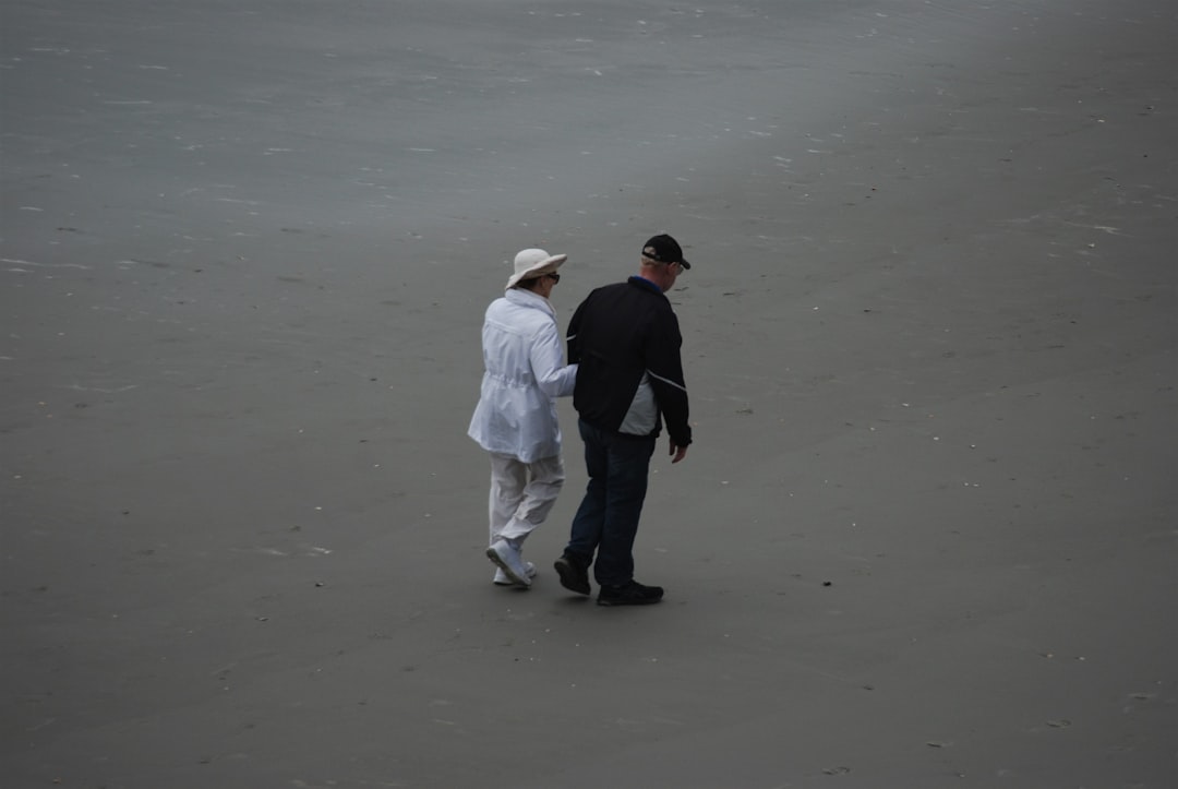 a man and a woman walking on a beach